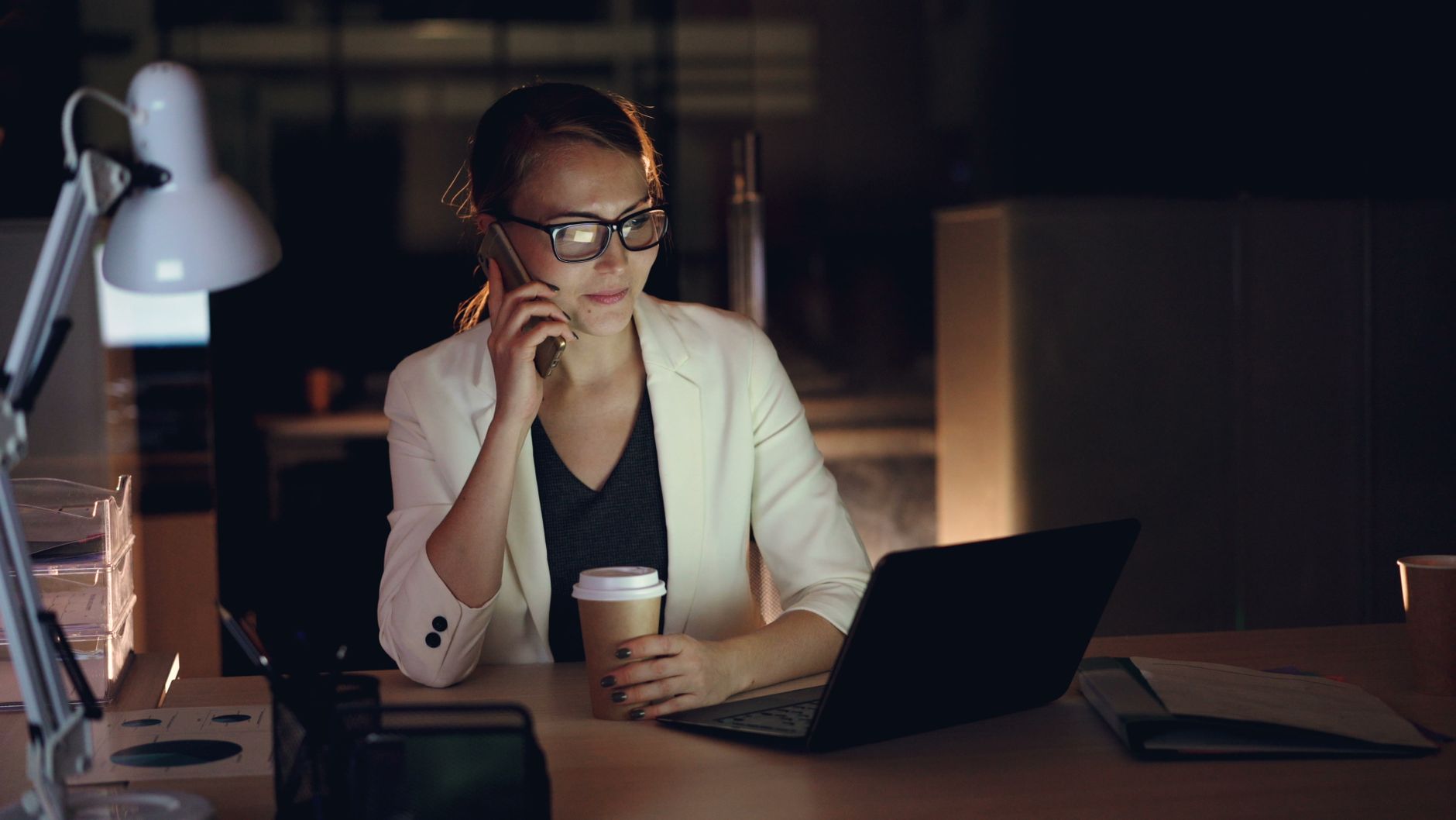 A teacher working late at a laptop